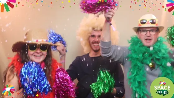 Trois invités agitent des pompons et des boas colorés